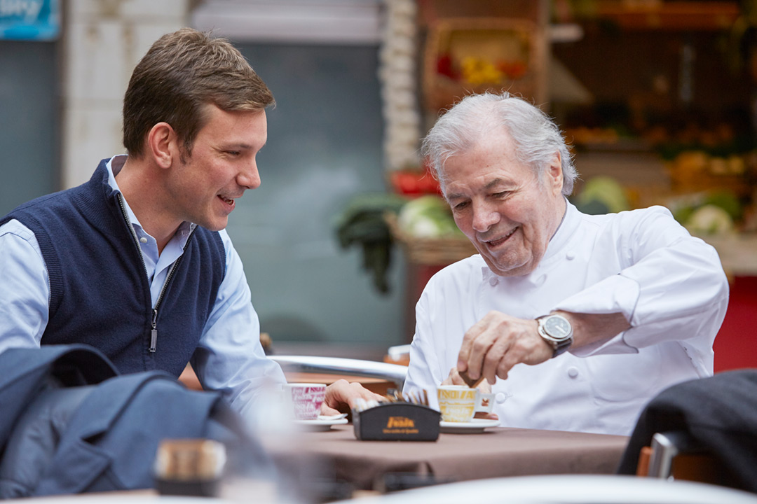 Photograph of Chef and Artist Jacques Pepin. Here’s Jacques with an admirer in France during an Oceanic Cruise.