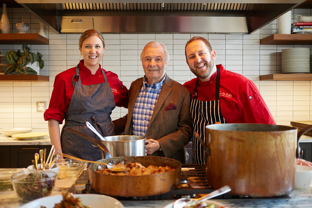 Photograph of Chef and Artist Jacques Pepin. Here’s Jacques with with several students. A portion of profits from the site go to help fund education and sustainability.