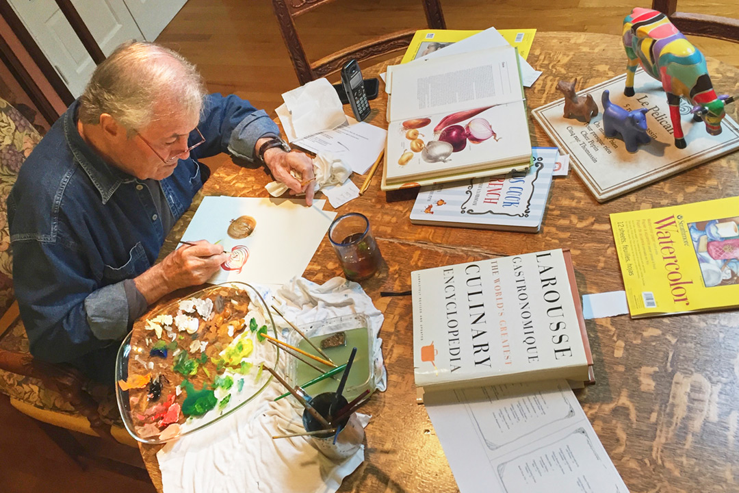 Photograph of Chef and Artist Jacques Pepin. Here’s Jacques at work in his home painter’s studio.