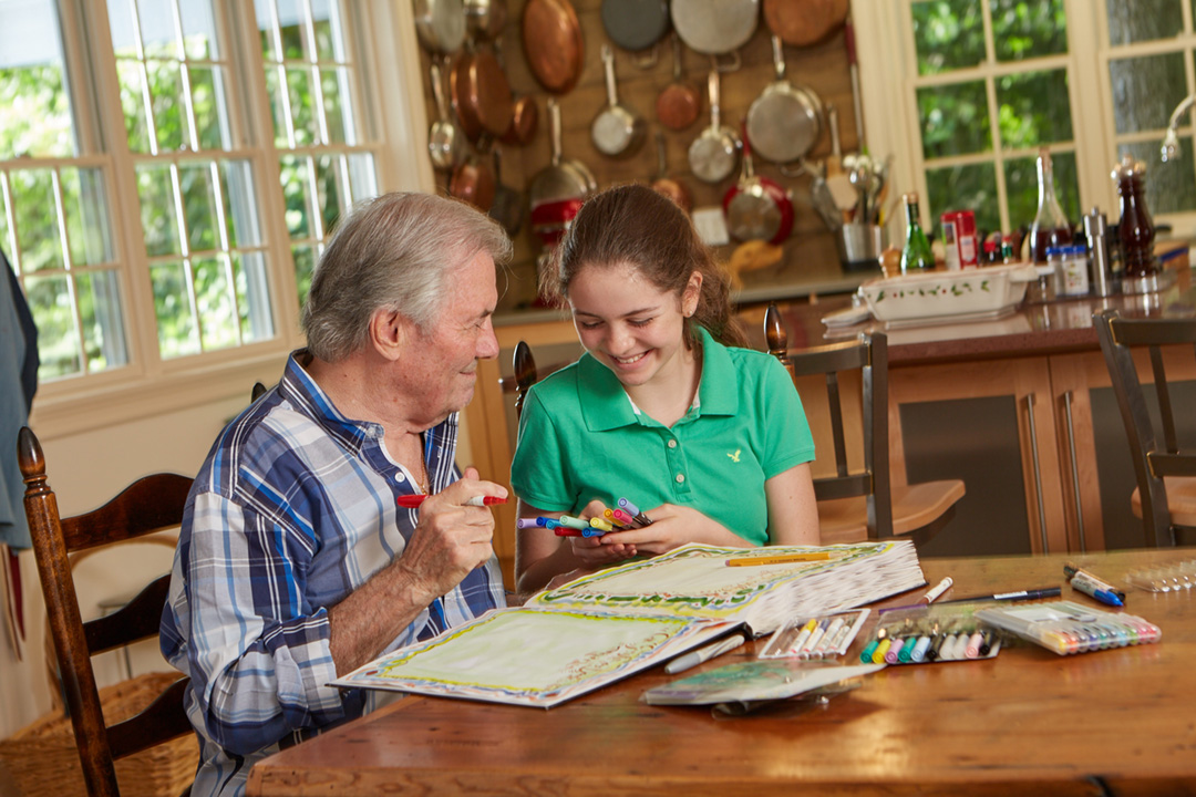 Jacques with his granddaughter, Shorey, at work on one of his many personalized menu books.