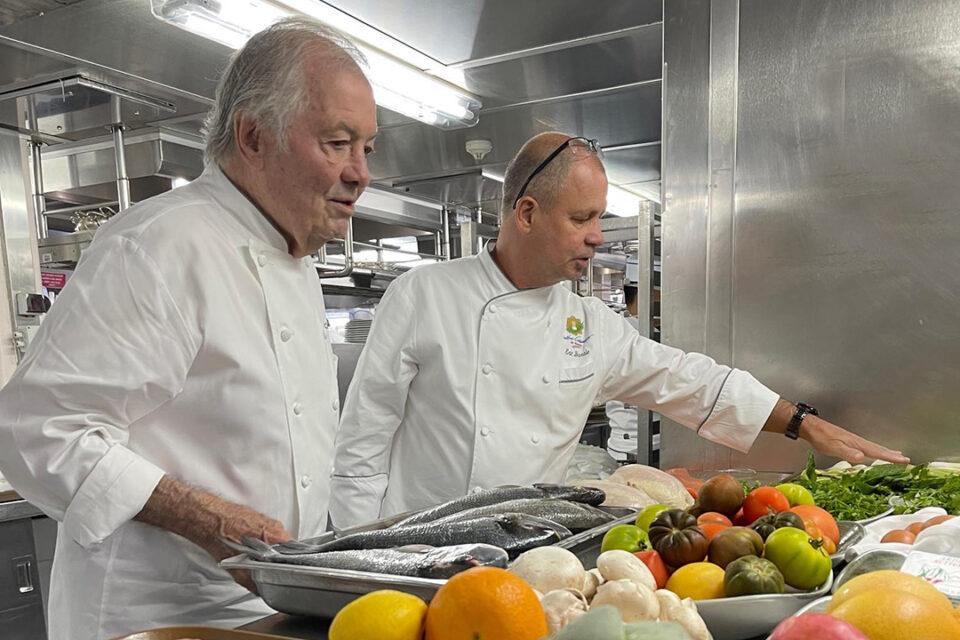 Oceania Cruises’ Executive Culinary Director Jacques Pepin with a member of the culinary staff in the ship’s kitchen.