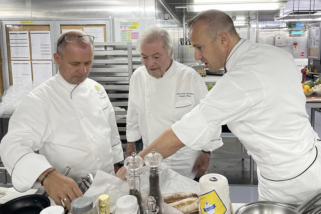 Oceania Cruises’ Executive Culinary Director Jacques Pepin with culinary staff in the ship’s kitchen.