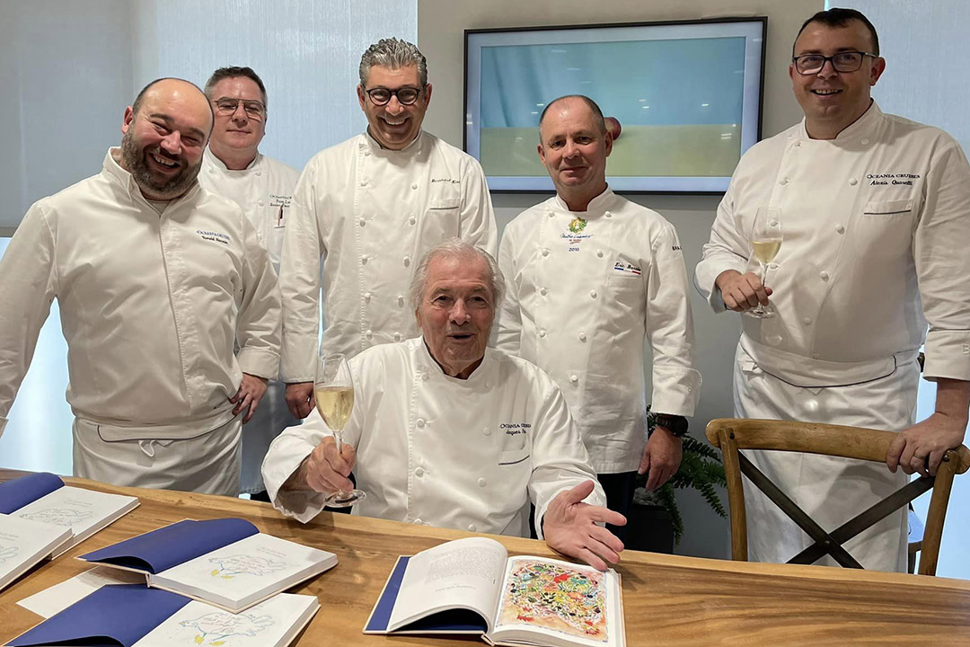 Oceania Cruises’ Executive Culinary Director Jacques Pepin at a book signing surrounded by some of the cruise ship’s culinary staff.