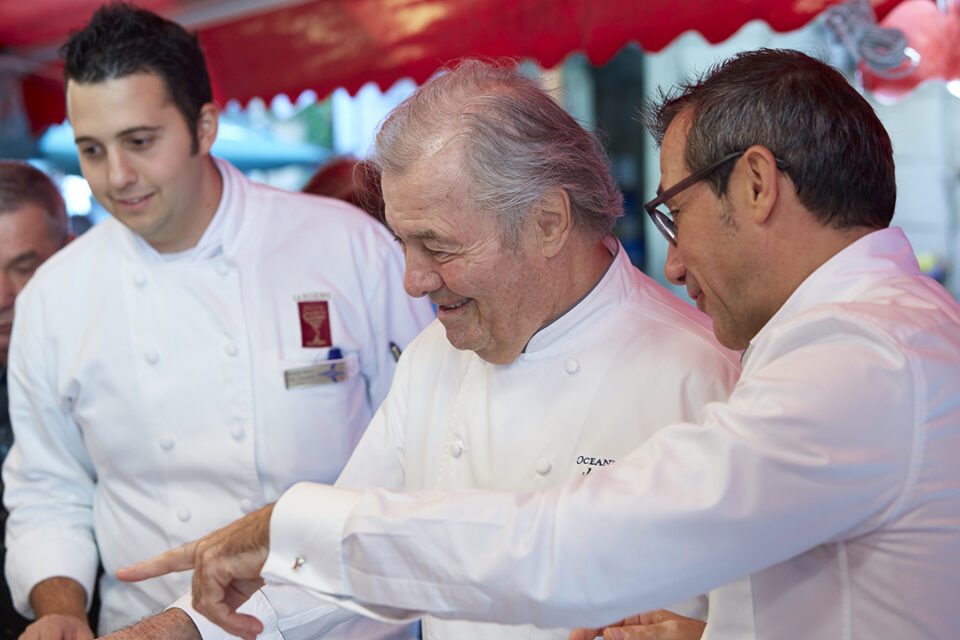 Oceania Cruises’ Executive Culinary Director Jacques Pepin choosing fresh produce in a port-of-call market. Oceania’s Culinary Director—France, Franck Garanger, is to Jacques’ left.
