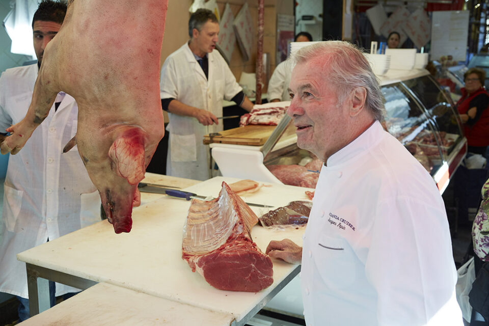 Oceania Cruises’ Executive Culinary Director Jacques Pepin in a butcher’s shop in a port-of-call.