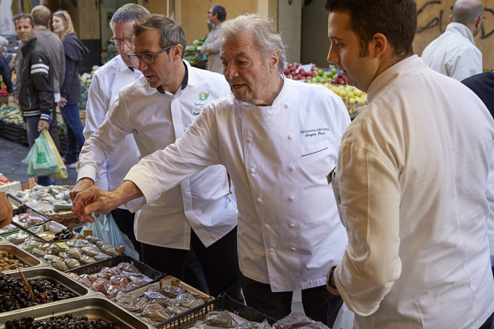 Oceania Cruises’ Executive Culinary Director Jacques Pepin choosing fresh produce in a port-of-call market. Oceania’s Culinary Director—France, Franck Garanger, is to Jacques’ right.